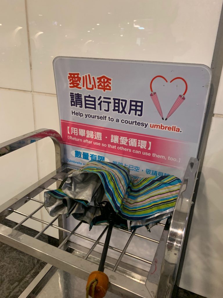 Some MRT stations have "courtesy umbrella" kiosks where you can take a free umbrella or pay-it-forward and leave one for another commuter.